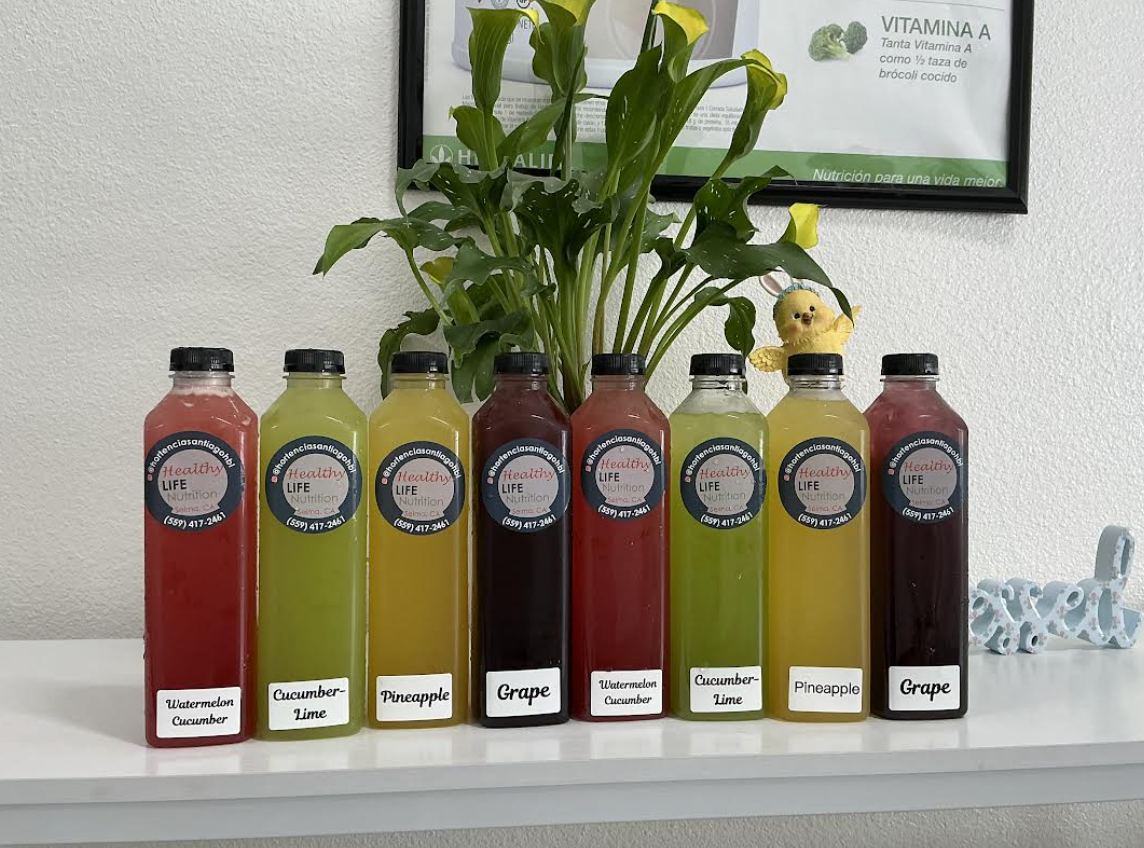 Assorted bottled fruit drinks lined up on a counter.